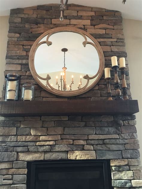 The round mirror with floating shelf is the apex of our functional mirrors. Stone fireplace round mirror arhaus | Mirror over ...