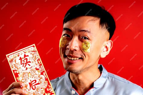 premium ai image photo happy chinese new year asian man holding chinese new year couplets on