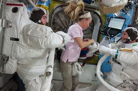 Nasa Astronaut Karen Nyberg Assisting Her Crewmates Wth Their