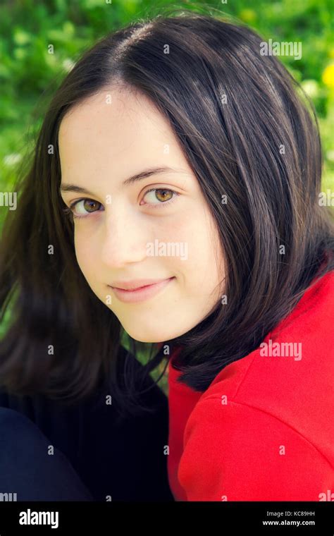Portrait Of A Beautiful Teenage Girl Smiling In The Park Stock Photo