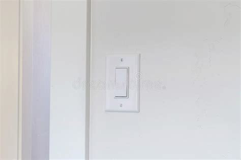 Indoor Electrical Light Switch Of Home Mounted On White Wall Background
