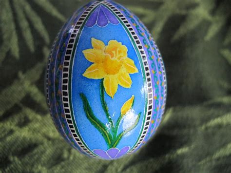An Easter Egg Decorated With Yellow Flowers