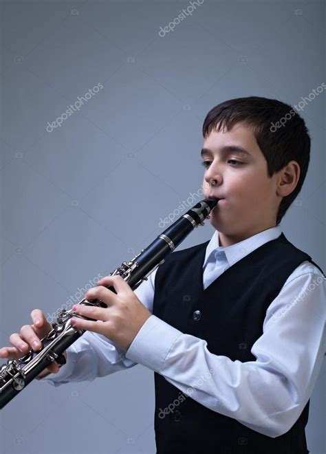 Boy Playing On The Clarinet — Stock Photo © Mesike 28425865