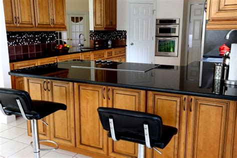 Satin white with black glaze kitchen cabinets new kitchen. How to Decorate with Black Counters & Cabinets in the Kitchen