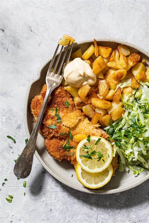 Schnitzels with baked potatoes and lettuce