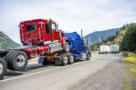 Powerful Blue Big Rig Semi Truck Transporting Another Semi Truck