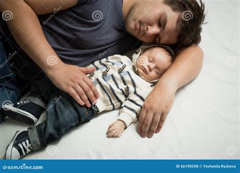 Young Father Sleeping On Bed With Newborn Baby Boy Stock Photo Image