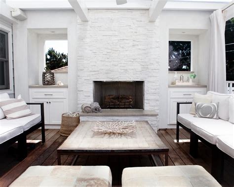 A White Painted Stone Fireplace Serves As The Focal Point Of This