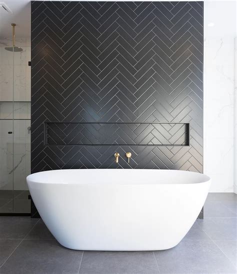 Bathrooms With Black Herringbone Tiles And White Freestanding Bathtub