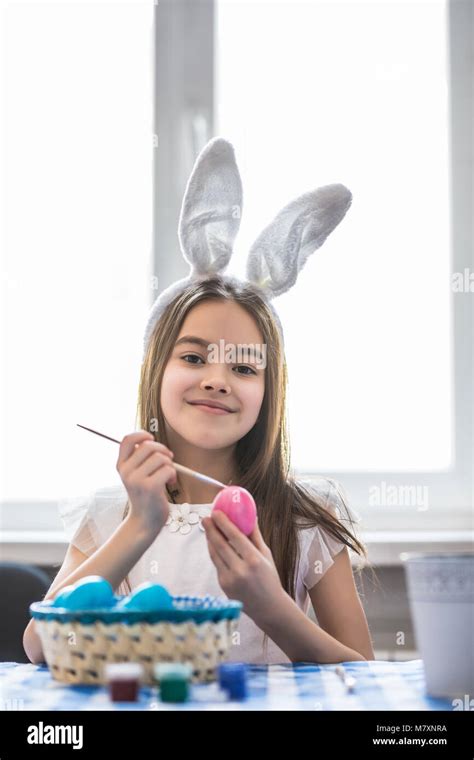 A Happy Little Girl Painting Easter Eggs Stock Photo Alamy