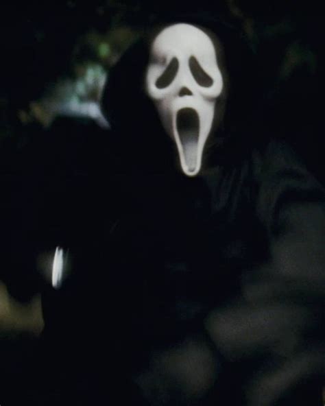 A Person Wearing A Ghost Mask With Their Mouth Open