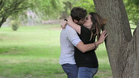 Man And Woman Passionate Kissing In A Public Park Couple In Love Stock