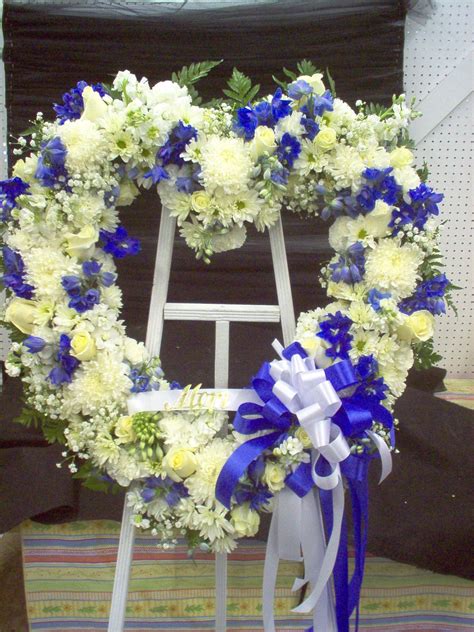 Evans peach green & blue funeral wreath in peabody, ma. Standing Heart Blue and white Roses, Mums, Carnations ...