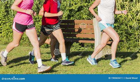 Group Of High School Girls Running Together In A Park Stock Image