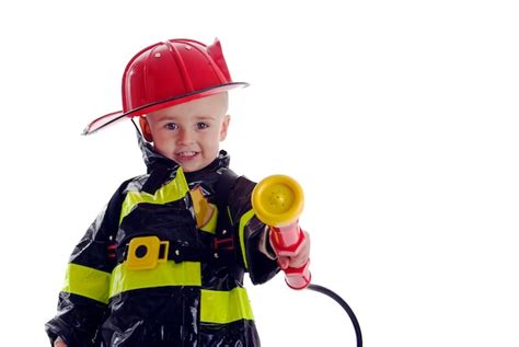 Premium Photo Portrait Of Cute Boy Holding Fire Hose While Wearing