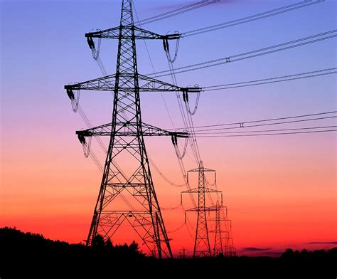Electricity Pylons And Transmission Lines At Sunset Photograph By Martin