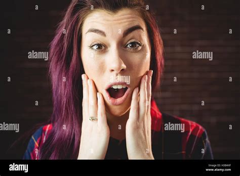 Young Woman Making A Surprised Facial Expression Stock Photo Alamy
