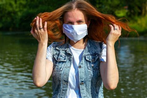 portrait of beautiful ginger girl wearing face mask in summer park stock image image of
