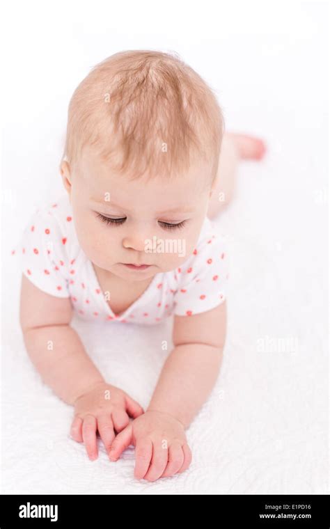 Cute Baby Girlplaying On A White Blanket Stock Photo Alamy