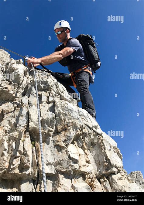 Mountain Guide On A Steep And Exposed Via Ferrata In Alta Badia In The