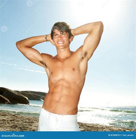 Stock Photo A Handsome Smart Guy Posing On The Beach Image