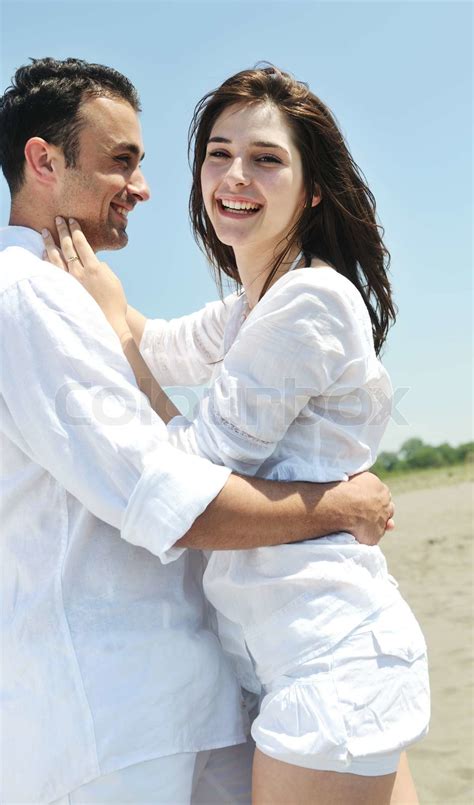 Happy Young Couple Have Fun On Beach Stock Image Colourbox