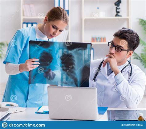 Two Doctors Examining X Ray Images Of Patient For Diagnosis Stock Image