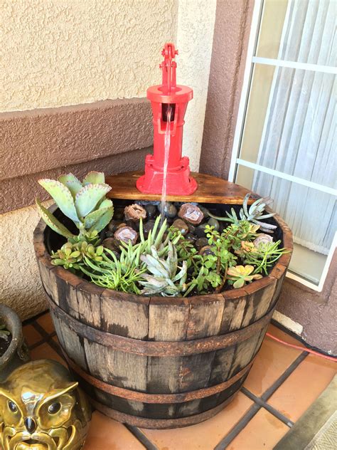 Whiskey barrel planter and fountain. | Whiskey barrel planter, Wine