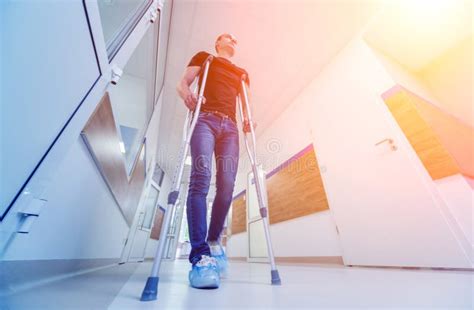Injured Man Trying To Walk On Crutches In The Hospital Stock Image