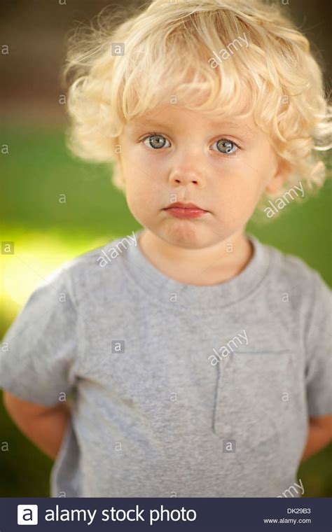 This haircut for toddler boys is for those having medium length hair, which flows down over the forehead and over the ears to give a simple and cute appearance. Blonde Toddler Boy Curly Hair Stock Photos & Blonde ...