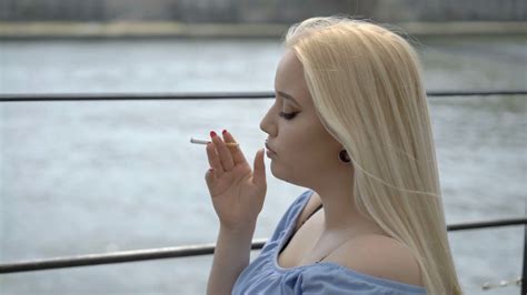 Pretty Girl Standing On The Boat And Smoking Cigarette Stock Video