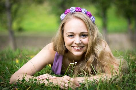 Beautiful Blonde Girl Is Lying In The Grass And Laughing Stock Image