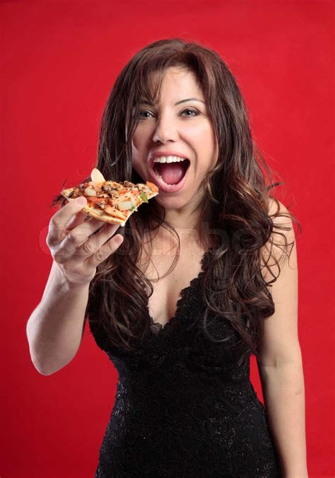 Sexede kvindelige spise en skive lækker pizza Stock foto Colourbox