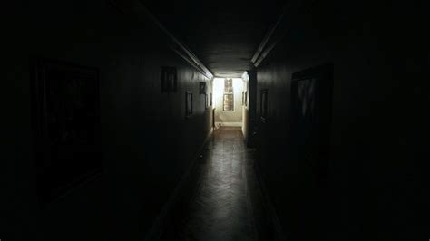 A Dark Hallway With Light Coming In From The Door