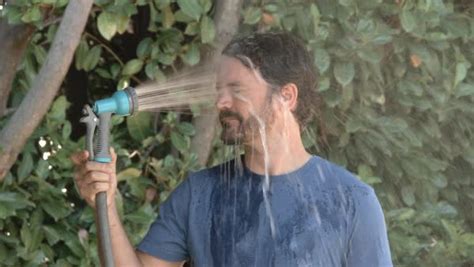 And summer 2021 is already breaking records. Slow motion of model released man spraying himself in the ...