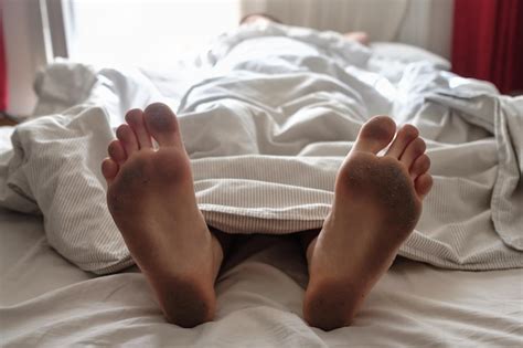 Premium Photo Dirty Bare Feet Of A Sleeping Person Showing Out Of The Blanket