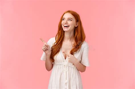 Charismatic Lovely European Redhead Woman In White Trendy Dress Showing Something Hilarious