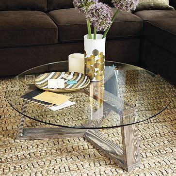 Tempered glass tabletop sits on a waved base made from sheet metal. Coffee tables, Round coffee tables and West elm on Pinterest