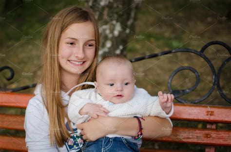 Teen Sister Holding Her Little Baby Brother High Quality People