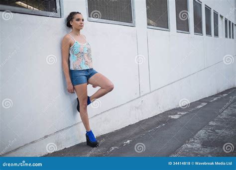 Attractive Woman Leaning Against A Wall Stock Photo Image Of