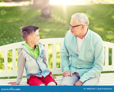 Grandfather And Grandson Talking At Summer Park Stock Image Image Of