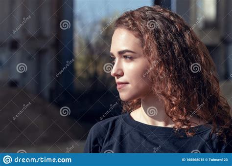 Close Up Portrait Of A Pretty Girl With Curly Hair In The Sun Flies On