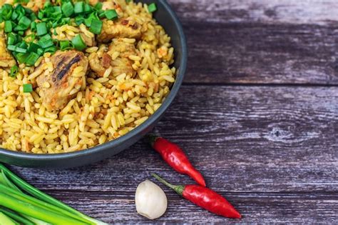 Premium Photo Rice Pilaf With Meat Carrot And Onion On Wood