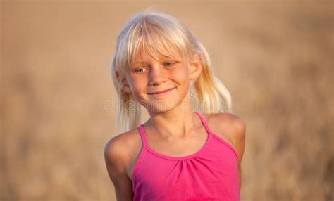 Beautiful Baby Girl With White Hair In A Wheat Field In Summer Stock