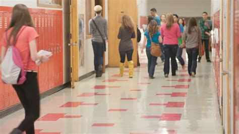 A Busy School Hallway With Students Walking To And From Class Stock