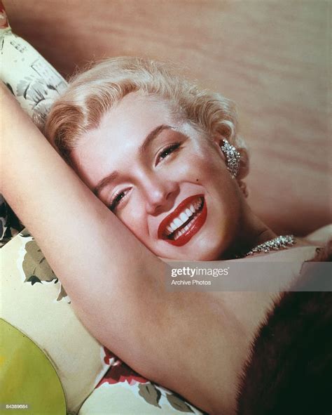American Actress Marilyn Monroe Lies Smiling On A Couch Circa