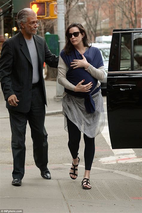 liv tyler swaddles newborn son sailor in a blue scarf while returning home to new york daily