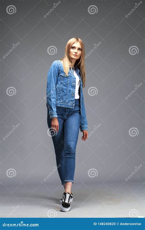 Beautiful Blonde Woman Dressed In A Denim Jacket And Blue Jeans Stock Photo Image Of Female
