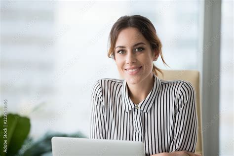 portrait of smiling beautiful millennial businesswoman or ceo looking at camera happy female