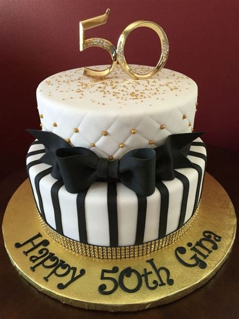 Happy 50th Gina Written In Black On A White And Gold Cake Decorated